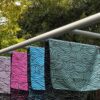 A towel thrown over equipment at a park in a scenic green backdrop