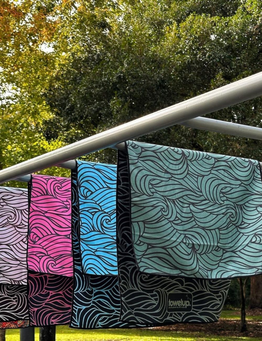 101 A towel thrown over equipment at a park in a scenic green backdrop