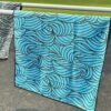 A towel thrown over equipment at a park in a scenic green backdrop