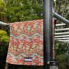 A towel thrown over equipment at a park in a scenic green backdrop