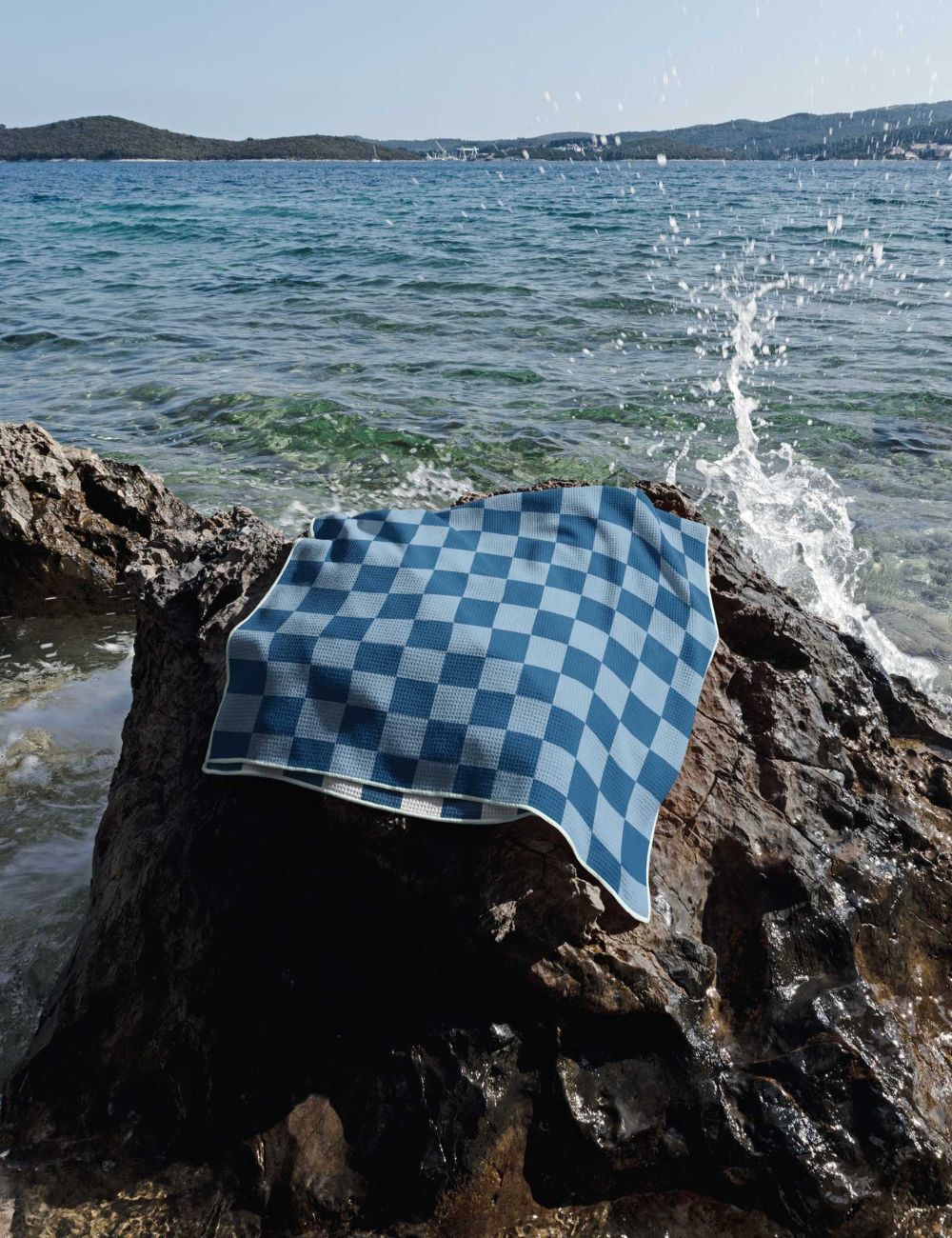 29 Beach towel on a rock by the sea