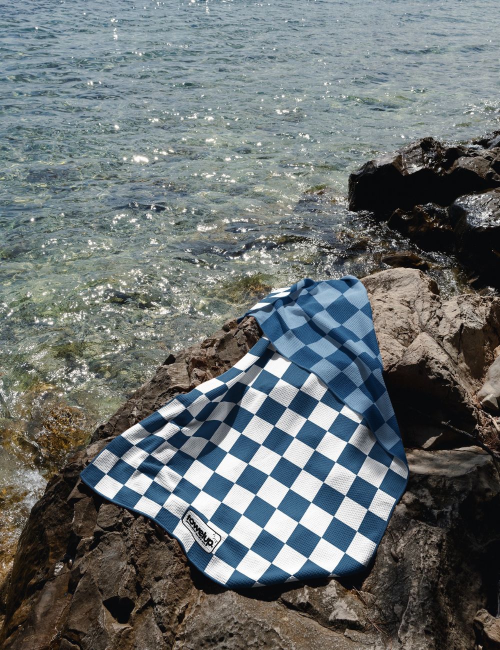 30 Beach towel on a rock by the sea