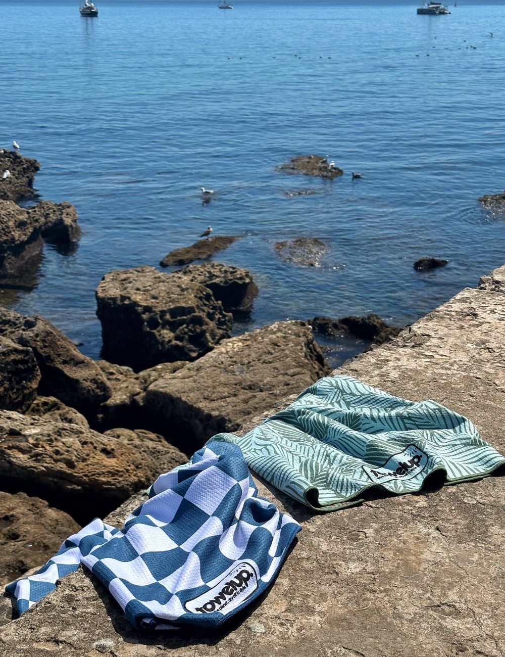 31 Beach towel on a rock by the sea
