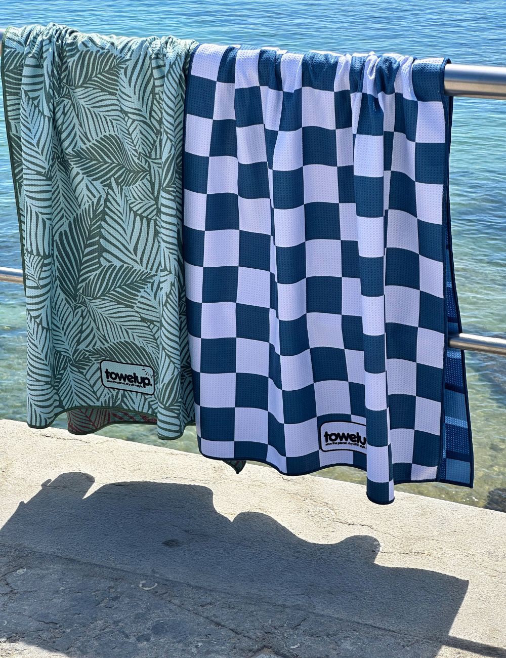 32 Beach towel on a rail by the sea