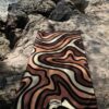 Beach towel on a rock by the sea