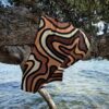 Beach towel hanging from a tree by the sea