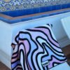 Beach towel hanging over a chair in scenic bright backdrop