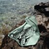 Beach towel on a rock by the sea