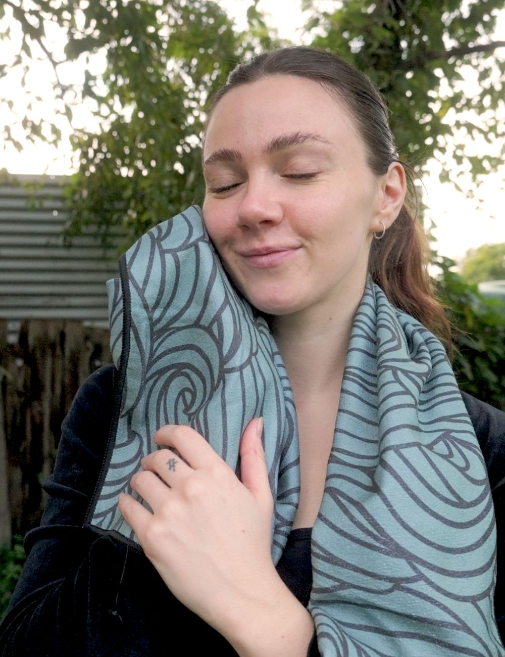 A gym towel being held up to show softness